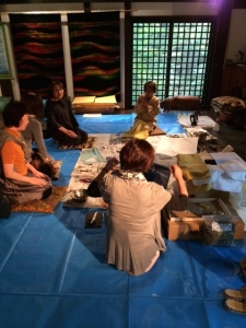 Some other women receiving instruction on how to design and dye their handkerchiefs