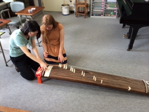 Our school's music teacher instructing the Australian music teacher on how to play the "noto"